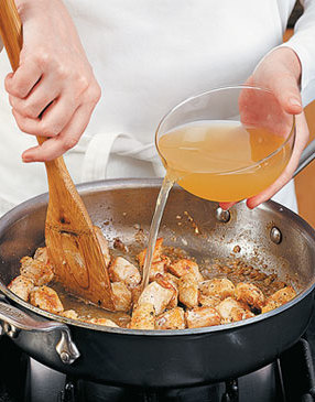 To reduce the risk of flour lumps, continuously stir chicken in the pan as you slowly add the juice mixture.