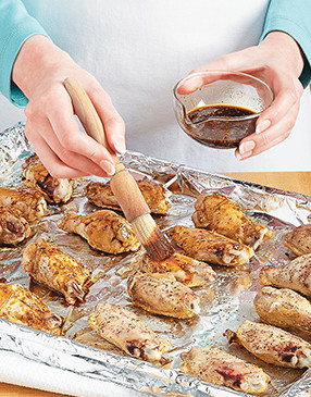 Ensure even cooking without burning the glaze by broiling the wings before basting them.