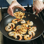 Cashews take the place of traditional peanuts in this soup. Stir-fry them with shrimp to toast lightly.