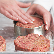Shaping the burgers in a mold before transporting them to the cookout site ensures uniform size and cooking time.