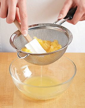 Thoroughly drain crushed pineapple by placing it in a sieve and pressing with a spatula.