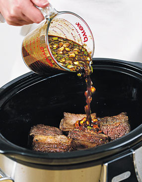 Pour the spicy-sweet sauce directly over the ribs in the slow cooker so that it glazes the ribs as they cook.
