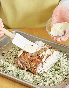 To help the bread crumb mixture adhere, add a layer of mayonnaise to the outside of the pork.