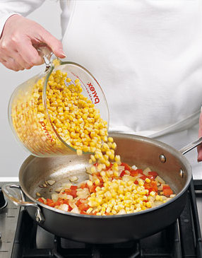 Add the frozen corn to the sauté pan. There’s no need to thaw it. Heat from the pan will do the job.