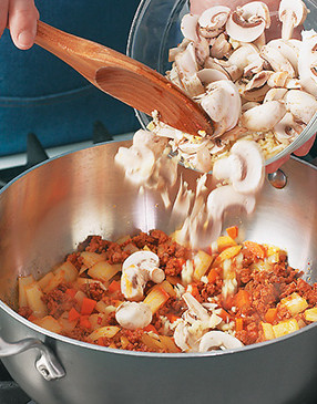 Saut&eacute; the sausage, onions, and carrots, then stir in and saut&eacute; the mushrooms and garlic.