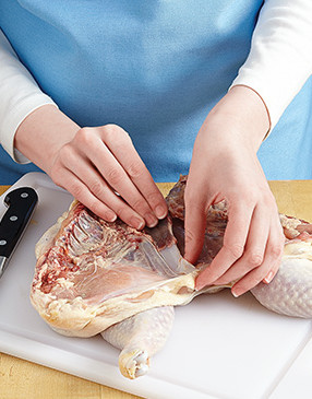 Once the keel bone is loose, use your thumb to separate it from the skin on both sides, then pull it out.