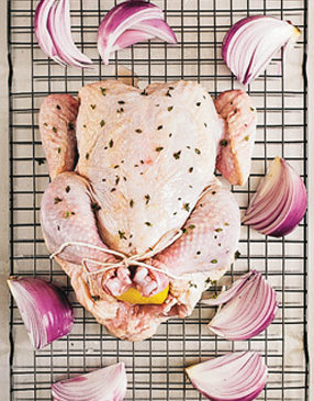 Tie the chicken legs together, leaving the drumsticks relaxed from the body.