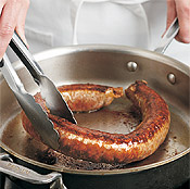 Saut&eacute;ing the sausage link whole, then slicing it after cooking, will yield cleaner and more even slices.