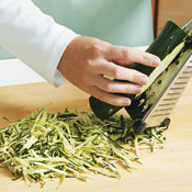 Shred zucchini down one side until you reach the seeds, then rotate to other side.