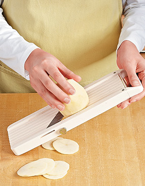 Use a mandoline to slice the potatoes. They'll cook evenly if they're the same thickness.