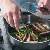 Add water to mushrooms and asparagus in skillet, then cover to steam. This keeps the vegetables from scorching. 