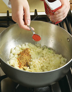 Add garlic, ginger, and spices to onions and saut&eacute; briefly to bring out the flavors of the spices.