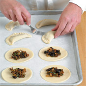 Use a fork to crimp the edges of the empanadas so they stay sealed and don’t pop open during baking.