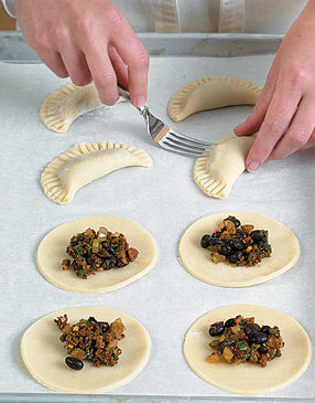 Use a fork to crimp the edges of the empanadas so they stay sealed and don’t pop open during baking.