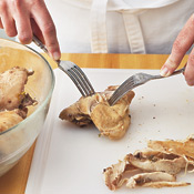 Allow the cooked chicken to cool slightly, then use two forks to shred the meat from the bones. 