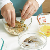 Dip the prepared shrimp in the butter-oil mixture, then dredge them in toasted bread crumbs.