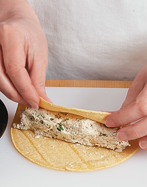 Roll tortillas firmly around filling and place in the pan, seam side down, so they hold together.