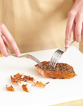 Remove the tough skin underneath the salmon, then to easily flake it, use two forks to break it apart.