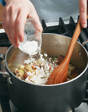 Sprinkle flour over sweated vegetables; stir constantly to coat and to prevent the flour from scorching.