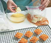 Dredge ravioli in flour, egg mixture, then bread crumbs. Briefly chill the breaded ravioli on a rack to set the crumbs.