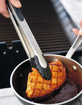 Once chicken reaches 165 degrees, dip it in glaze. Briefly return chicken to the grill to caramelize glaze.