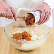 After beating cream cheese and sugar together until fluffy, add pumpkin purée and spices.