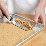 Spread the crust into an even layer on a baking sheet lined with parchment paper.