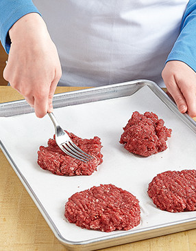Using a fork to lightly shape the burgers ensures you don’t compress them, making them tough.