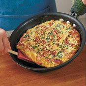 After removing frittata from the broiler, run a rubber spatula under the frittata to loosen it, then slide the frittata onto a cutting board. 