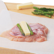 Make sure the ham is shaved thin for easy rolling. Divide ham, cheese blocks, and asparagus among chicken breasts.