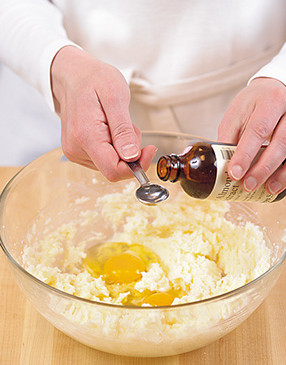 Beat together the creamed butter mixture, eggs, and almond extract before adding the flour mixture.
