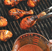 Partially grill the legs, then dip them into the basting sauce. Return the chicken legs to the grill.