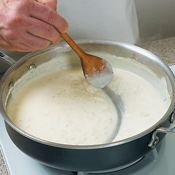 Reduce cream mixture until it's thick enough to leave a trail when you draw a spoon across the bottom of the pan. 