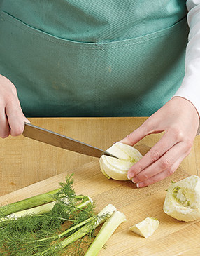 Once you’ve trimmed the stalks and root end, slice the fennel bulb in half, then remove the center core.