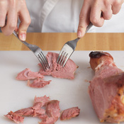 Slice turkey meat from the leg, then use two forks to shred it. One leg should yield 2 cups of meat.