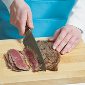 The steak will be easier to eat if it's thinly sliced against the grain. Cut the meat at an angle.