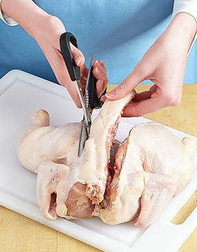 With the breast side down, cut along the sides of the backbone with kitchen shears to remove.