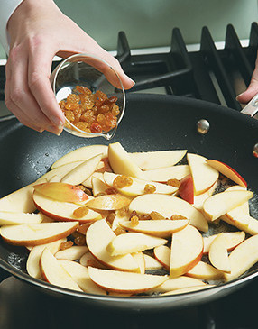 Add raisins to the apples. Golden raisins look nice in the dish, but dark ones work fine too.