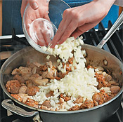 Saut&eacute; the chicken and sausage chunks with the onion in olive oil until browned.