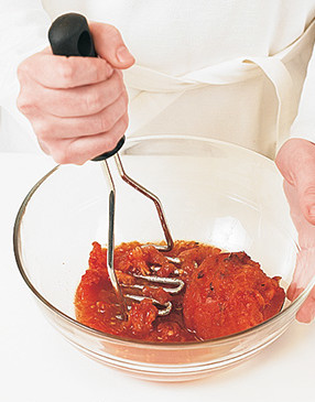 To easily give the sauce a chunky consistency, crush the tomatoes with a potato masher.