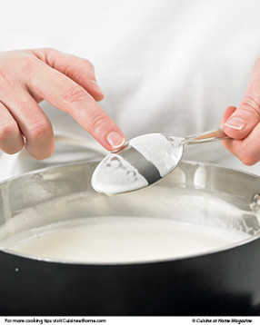 Gently cook (don't boil) the custard until it thickens and coats a spoon, leaving a trail that doesn't quickly disappear.