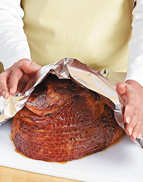 Tenting the ham with foil keeps the ham warm while the juices in the meat redistribute.