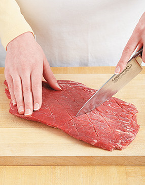 Make the marinade more effective by cutting a very shallow diamond pattern into the steak.