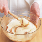 Fold the egg-sugar mixture into the chocolate mixture to create a velvety smooth filling for the pie.