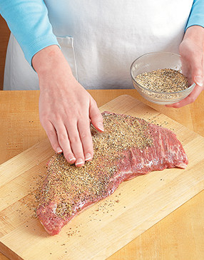 Evenly rub spices onto the roast to enhance its flavor. A light coat of oil on the meat helps them stick.