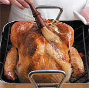 Baste turkey with drippings from the bottom of the pan to keep the skin moist and help it brown.