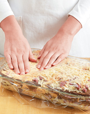 Press down on the strata to encourage the bread to absorb the egg-milk mixture.