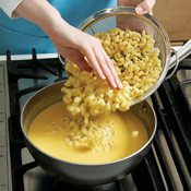 After the cheese has melted, add the macaroni, stirring to break up any clumps. Do not let the soup boil.