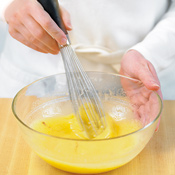 Whisk sugar and eggs with the drippings and oil. Stop whisking when the mixture lightens in color.