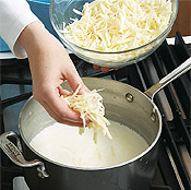 Add cheeses to warm milk mixture and stir until smooth. Take care not to let the sauce boil or it could turn grainy.